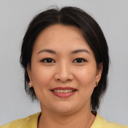 Joyful asian young-adult female with medium  brown hair and brown eyes