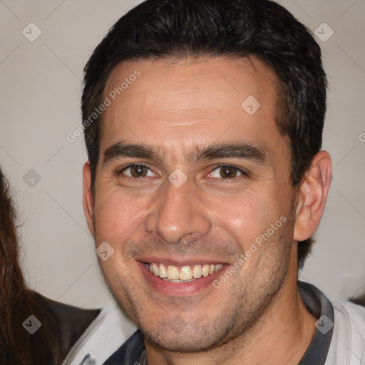 Joyful white adult male with short  brown hair and brown eyes