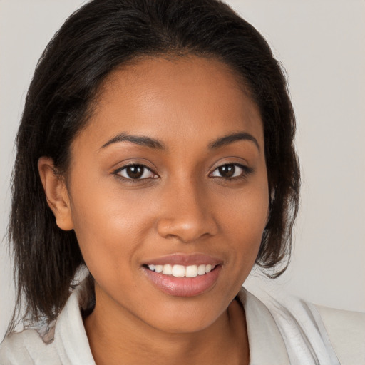 Joyful latino young-adult female with medium  brown hair and brown eyes