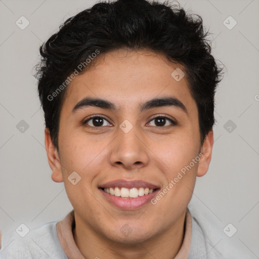 Joyful latino young-adult male with short  brown hair and brown eyes