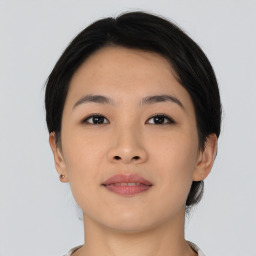 Joyful asian young-adult female with short  brown hair and brown eyes