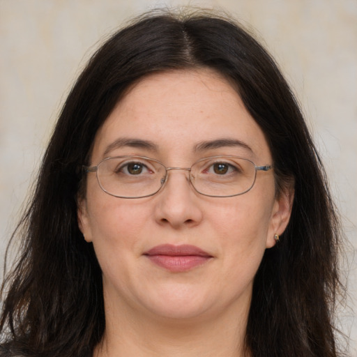 Joyful white adult female with long  brown hair and brown eyes