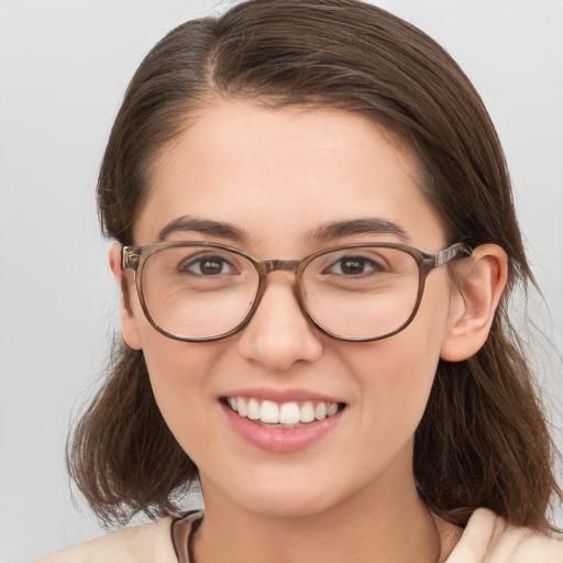 Joyful white young-adult female with medium  brown hair and brown eyes