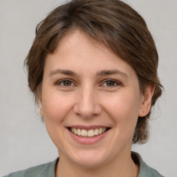 Joyful white young-adult female with medium  brown hair and brown eyes