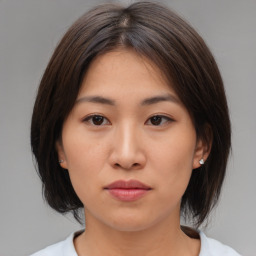 Neutral asian young-adult female with medium  brown hair and brown eyes