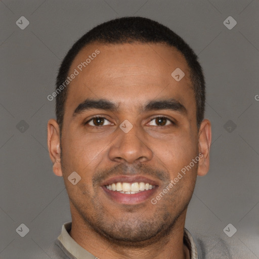 Joyful black young-adult male with short  brown hair and brown eyes