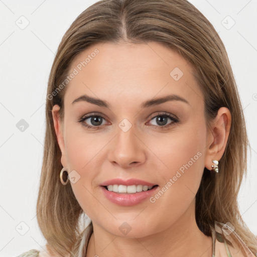 Joyful white young-adult female with long  brown hair and blue eyes