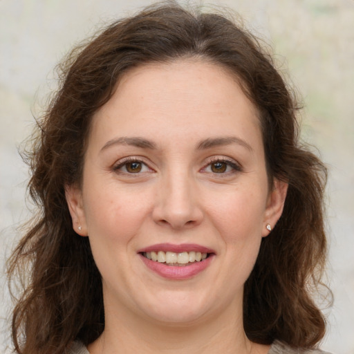 Joyful white young-adult female with long  brown hair and green eyes