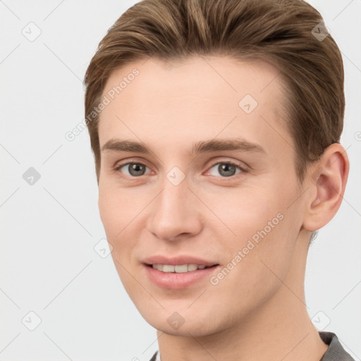 Joyful white young-adult female with short  brown hair and grey eyes