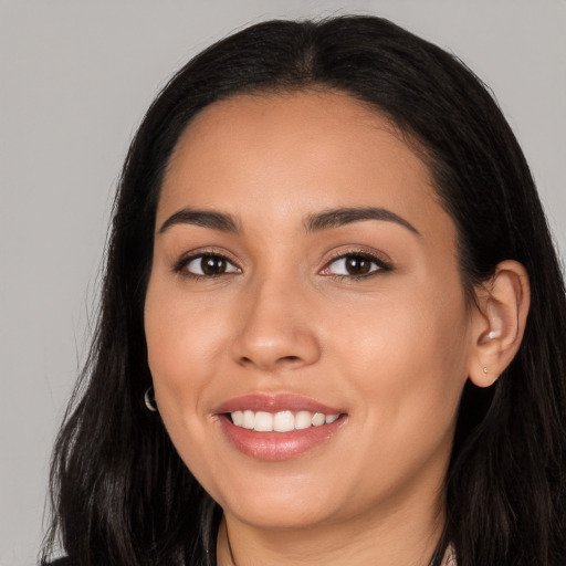 Joyful white young-adult female with long  black hair and brown eyes