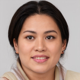 Joyful white young-adult female with medium  brown hair and brown eyes