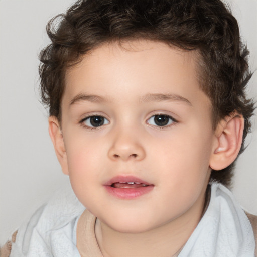 Joyful white child male with short  brown hair and brown eyes