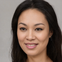 Joyful asian young-adult female with long  brown hair and brown eyes