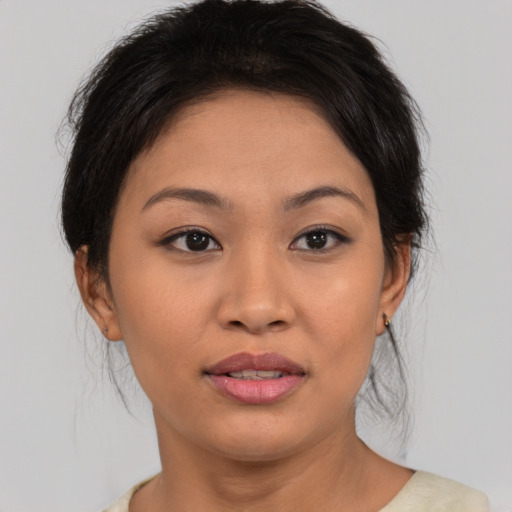 Joyful asian young-adult female with medium  brown hair and brown eyes