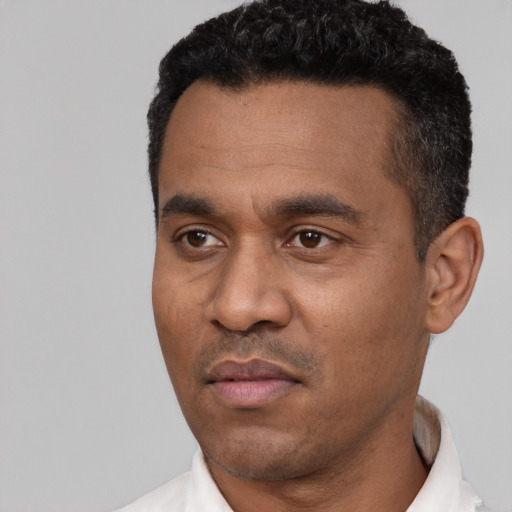 Neutral latino adult male with short  black hair and brown eyes