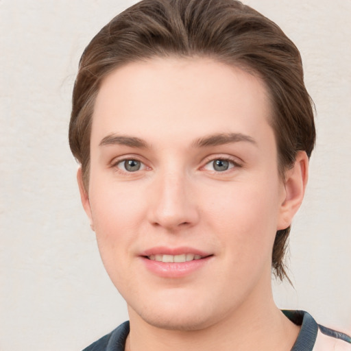 Joyful white young-adult female with short  brown hair and grey eyes