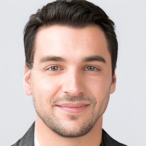 Joyful white young-adult male with short  black hair and brown eyes