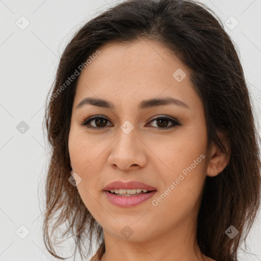 Joyful latino young-adult female with long  brown hair and brown eyes