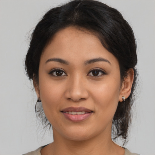 Joyful latino young-adult female with medium  brown hair and brown eyes