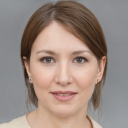 Joyful white young-adult female with medium  brown hair and grey eyes