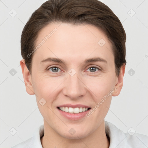 Joyful white young-adult female with short  brown hair and grey eyes