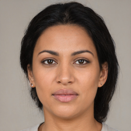 Joyful latino young-adult female with medium  black hair and brown eyes