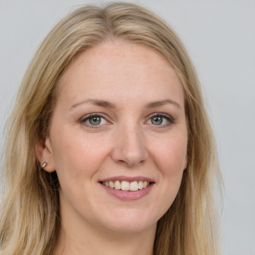 Joyful white young-adult female with long  brown hair and blue eyes