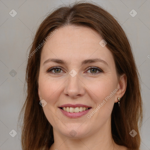 Joyful white adult female with long  brown hair and brown eyes