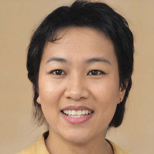 Joyful asian young-adult female with medium  black hair and brown eyes