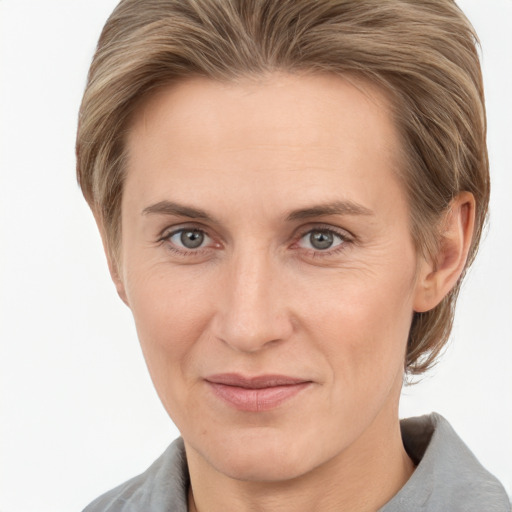 Joyful white adult female with medium  brown hair and grey eyes