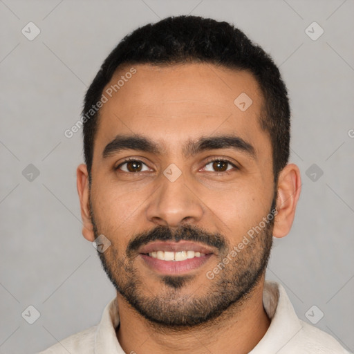 Joyful latino young-adult male with short  black hair and brown eyes