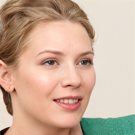 Joyful white young-adult female with short  brown hair and blue eyes