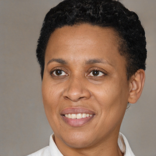 Joyful black adult female with short  brown hair and brown eyes