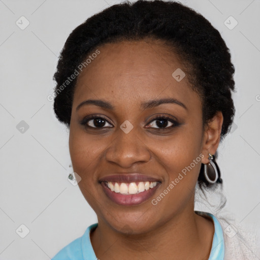 Joyful black young-adult female with short  black hair and brown eyes