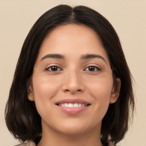 Joyful white young-adult female with medium  brown hair and brown eyes