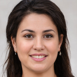 Joyful white young-adult female with long  brown hair and brown eyes