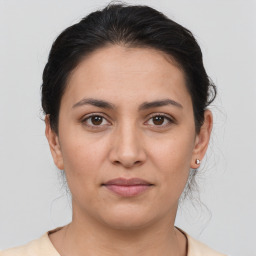 Joyful white young-adult female with medium  brown hair and brown eyes