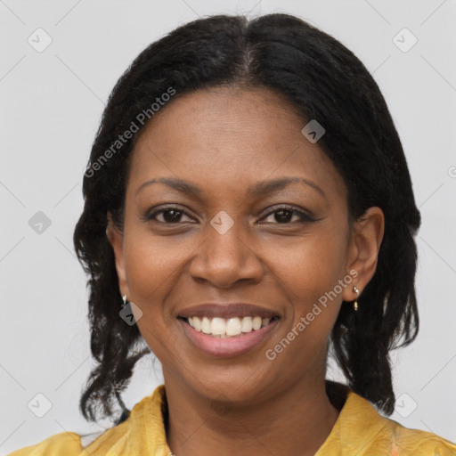 Joyful black young-adult female with long  brown hair and brown eyes