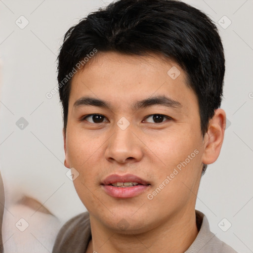 Joyful asian young-adult male with short  black hair and brown eyes