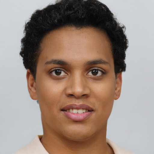 Joyful black young-adult female with short  brown hair and brown eyes
