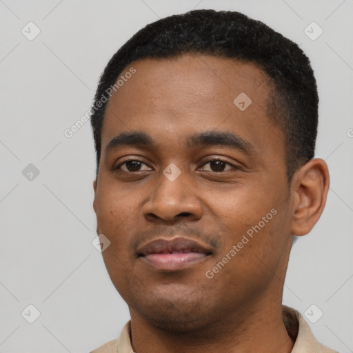 Joyful black young-adult male with short  black hair and brown eyes