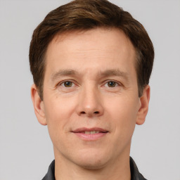 Joyful white adult male with short  brown hair and brown eyes