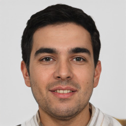 Joyful white young-adult male with short  black hair and brown eyes