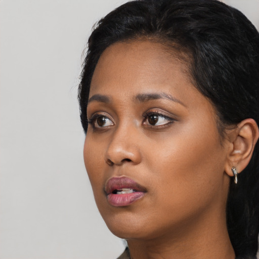 Neutral black young-adult female with long  black hair and brown eyes