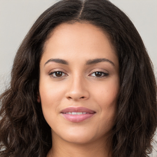 Joyful latino young-adult female with long  brown hair and brown eyes