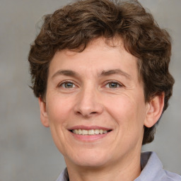 Joyful white adult male with short  brown hair and grey eyes