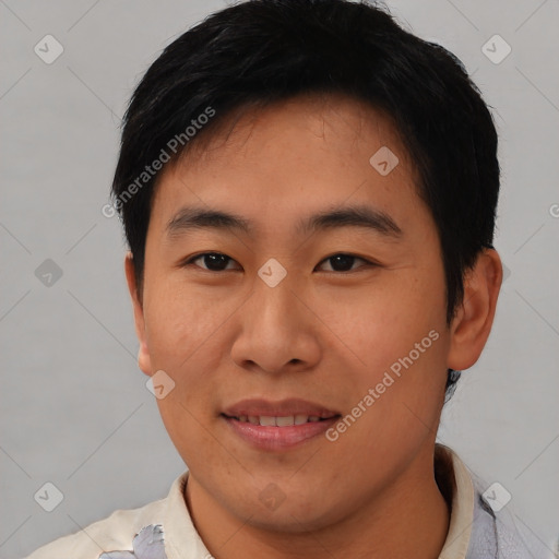 Joyful asian young-adult male with short  black hair and brown eyes