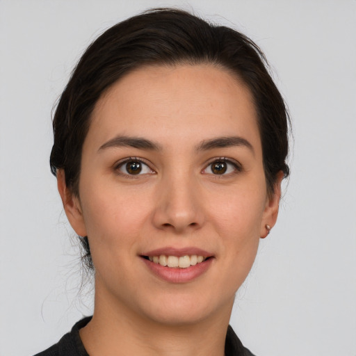 Joyful white young-adult female with medium  brown hair and brown eyes