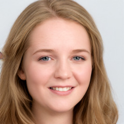 Joyful white young-adult female with long  brown hair and blue eyes