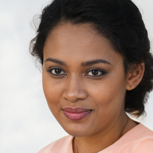 Joyful black young-adult female with medium  brown hair and brown eyes